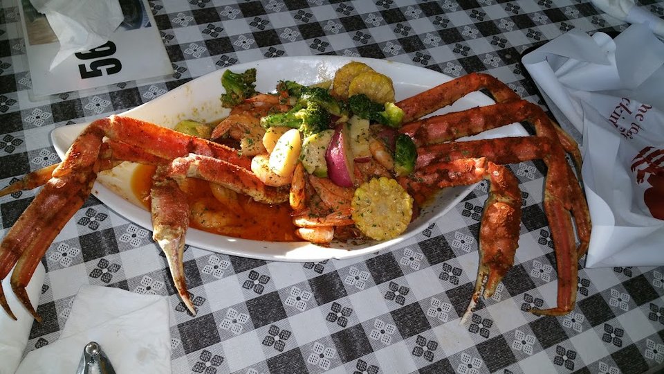 Printed menu showing seafood dishes and drink options.