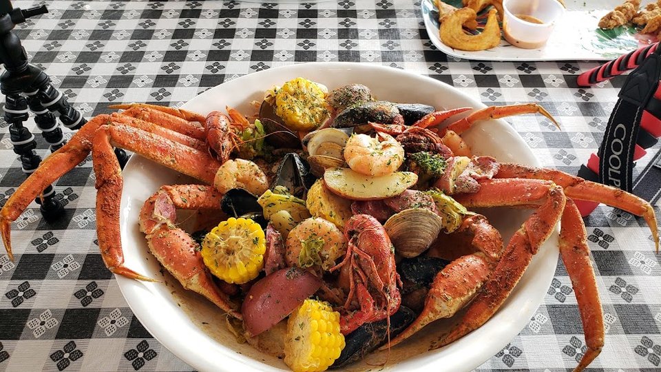 Printed menu showing seafood dishes and drink options.
